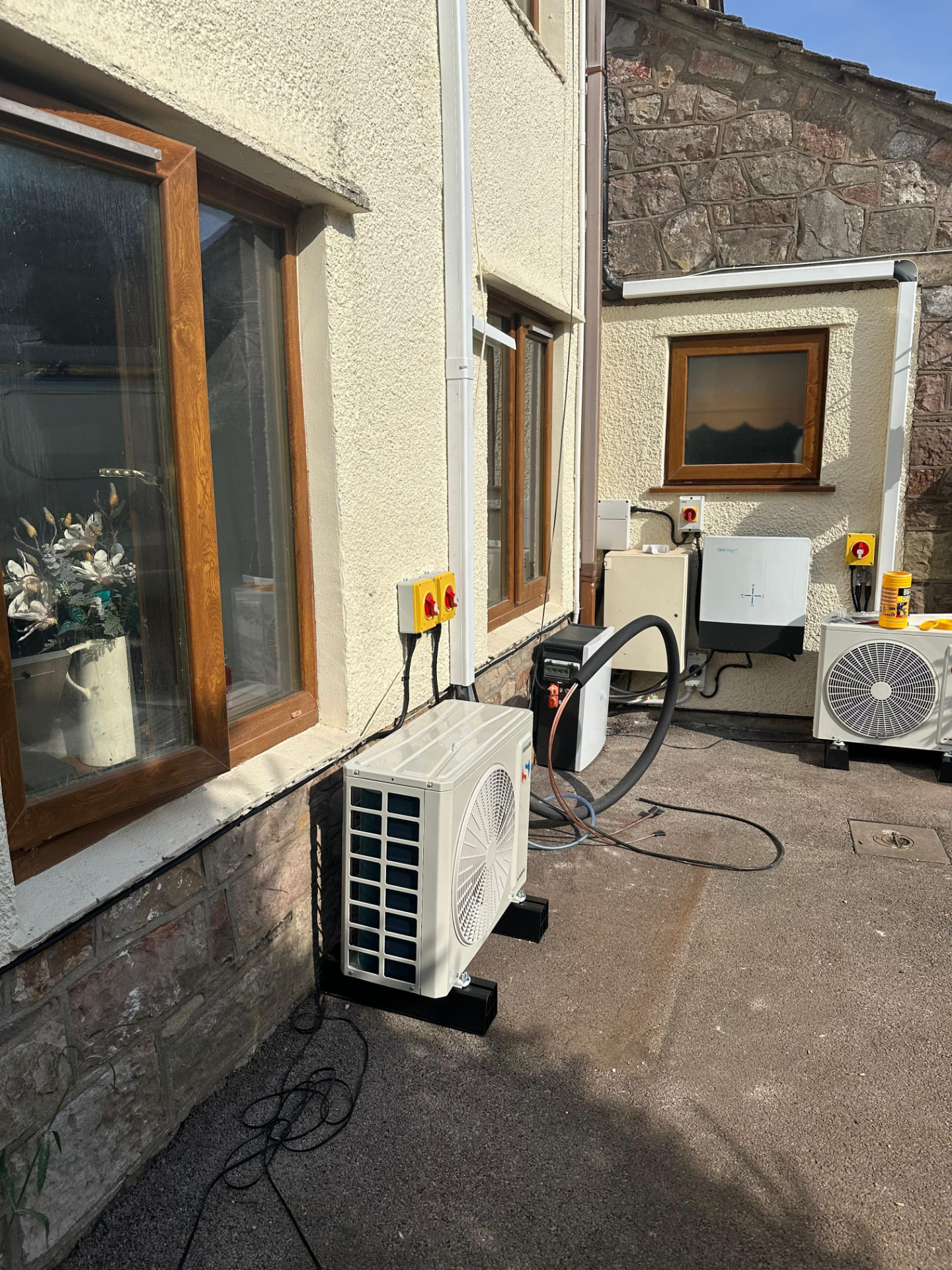 Air conditioning outdoor unit with new electrical supply installed to a domestic wall