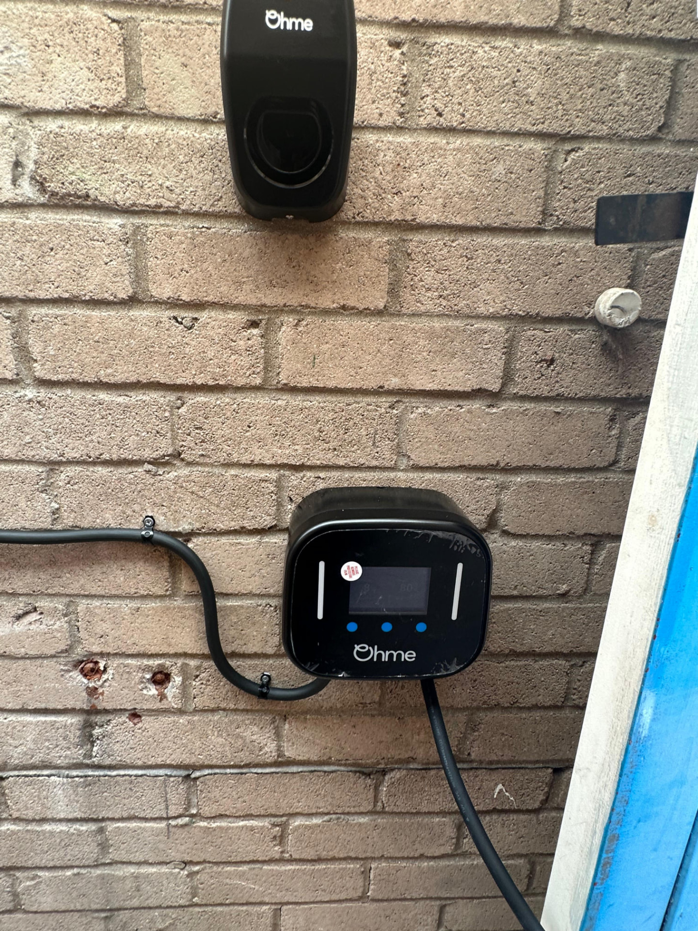 Ohme home EV charger installed on a stone wall by NAPIT registered electrician