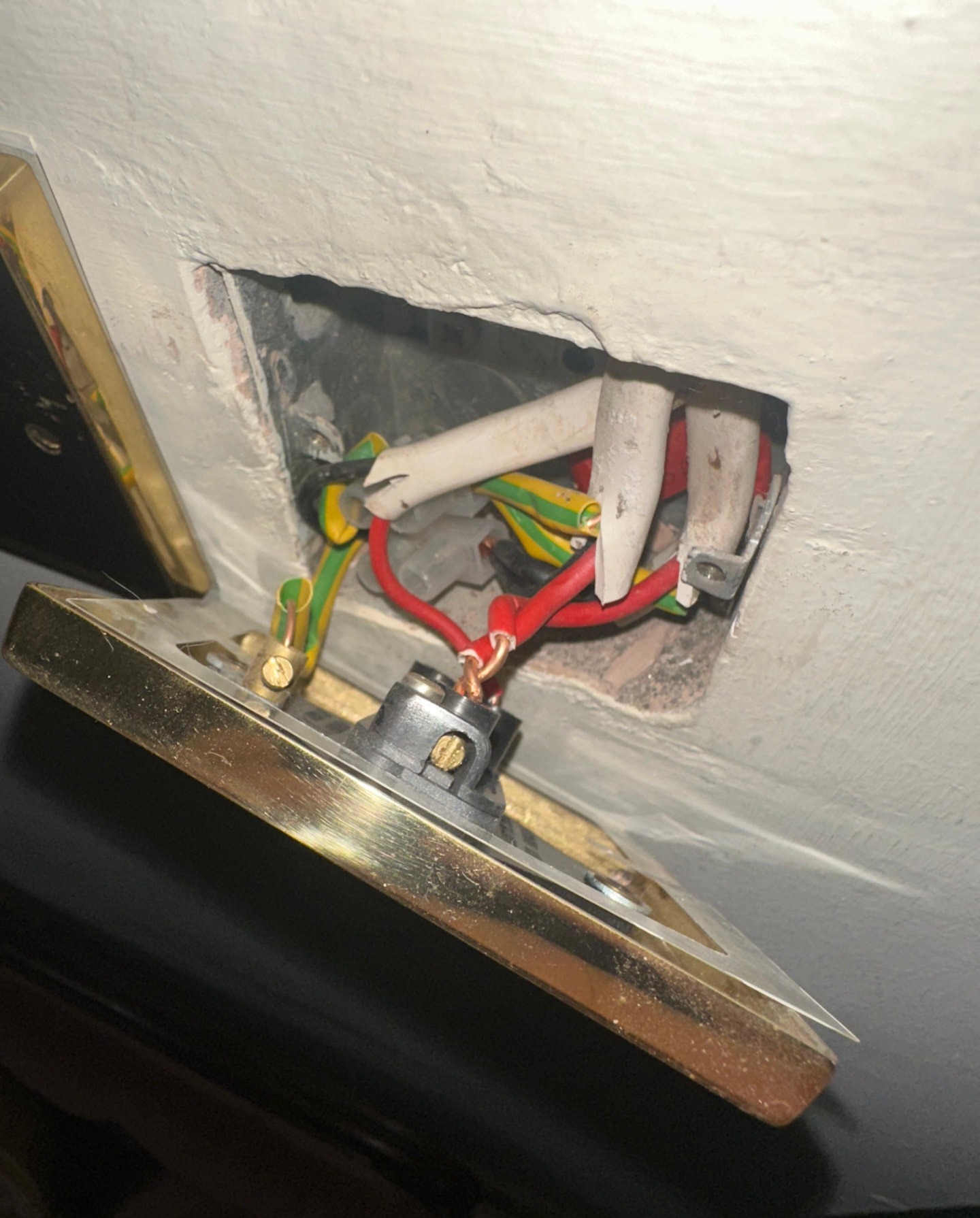Poorly terminated brass light switch found during a landlord EICR safety inspection
