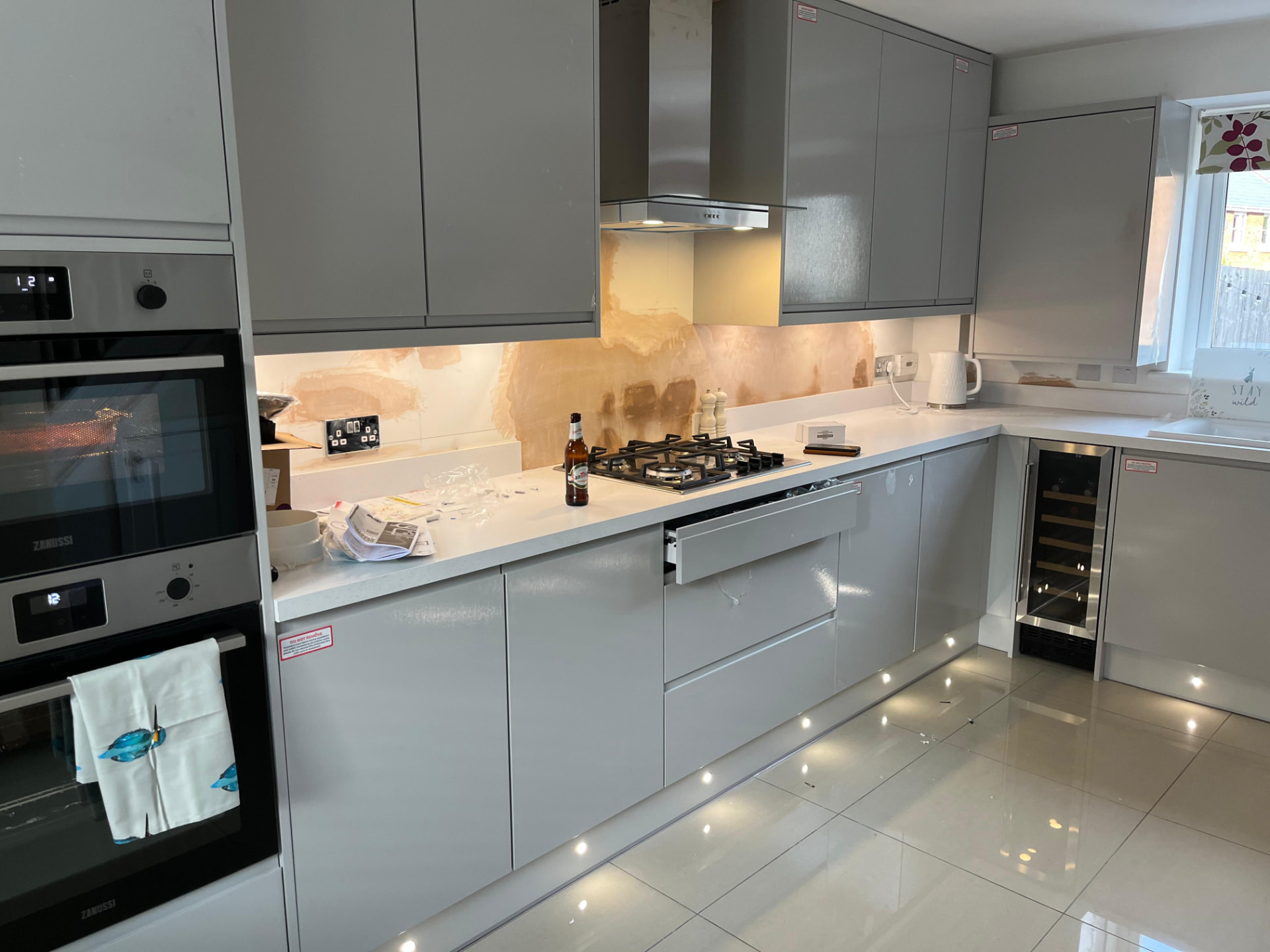 Modern kitchen with under cabinet and plinth LED lighting installed for ambience and task work