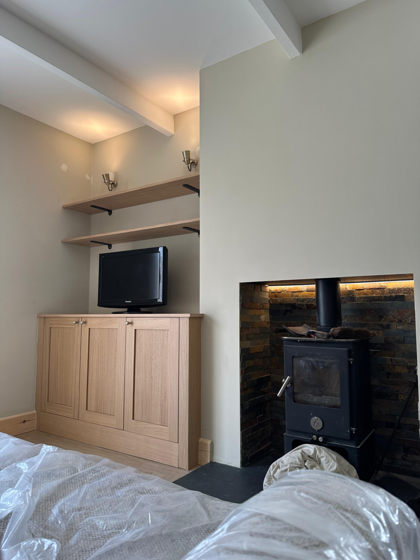 Cosy living room with fireplace and cabinet accent lighting installed by H&H Electrical